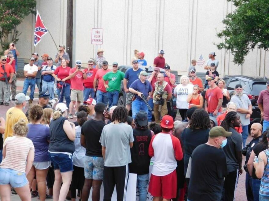 Protesters and armed counterprotesters face off during a demonstration in Gainesville in July 2020.