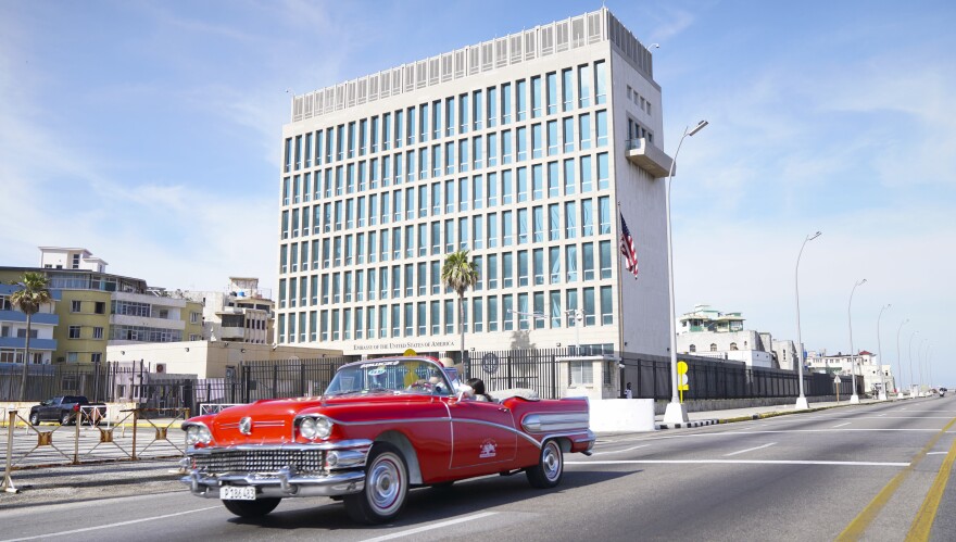 A car drives past the U.S. Embassy in Havana in 2019. Americans working at the embassy began reporting unexplained illnesses in 2016.