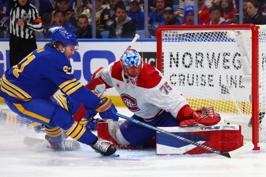 Buffalo Sabres right wing Josh Doan, left, is stopped by Montréal Canadiens goaltender Jakub Dobes (75) during the first period in Game 1 of a second-round NHL hockey Stanley Cup playoff series, Wednesday, May 6, 2026, in Buffalo, N.Y.