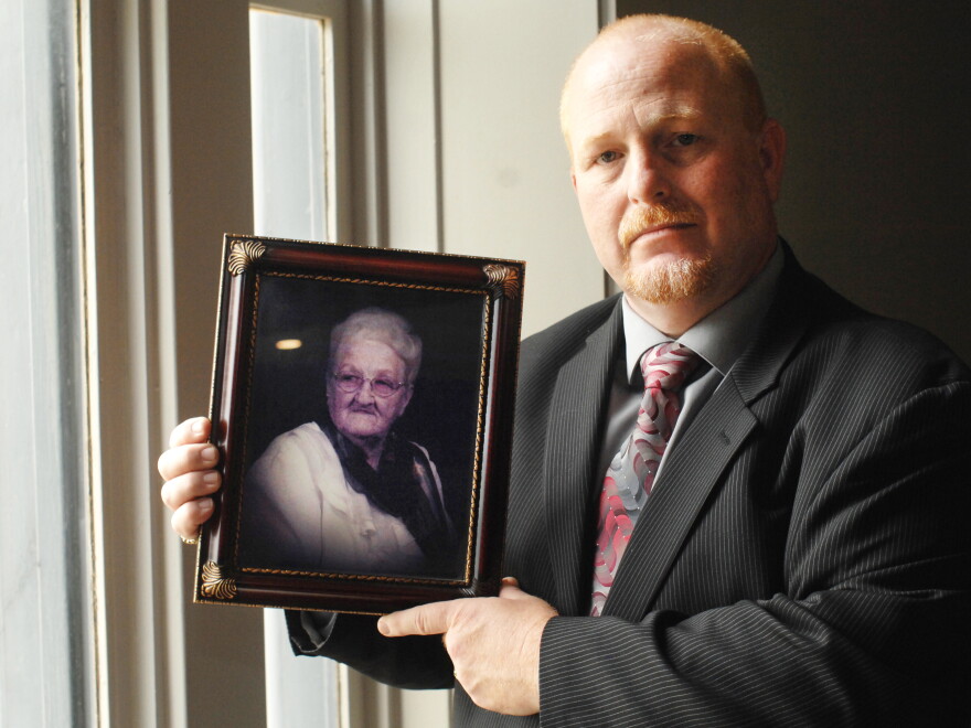 State long-term care ombudsman Bill Whited, holding a picture of his grandmother, Pearl Wolf.