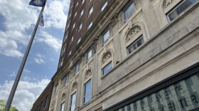 Exterior of the Lexington Fayette Government Center building at a low angle, the flagpole shown at full height to the left.