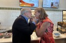 Gov. Mike and First Lady Fran DeWine share a Schmidt's Cream Puff in front of reporters at the Ohio State Fair in 2026.