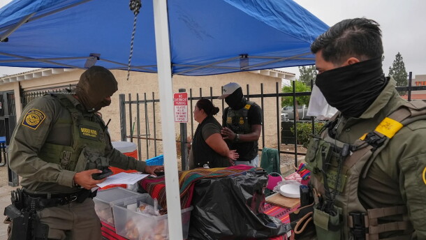 A woman is detained by U.S. Border Patrol agents outside a Home Depot in Los Angeles on Aug. 15, 2025.