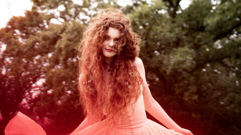 a woman in a dress posing for a photo