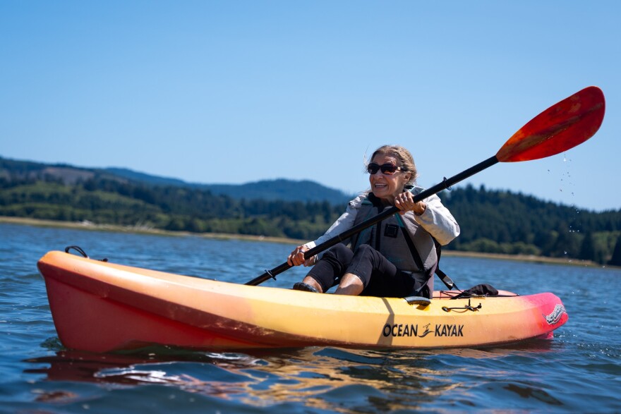 A woman kayaks on the salmon river