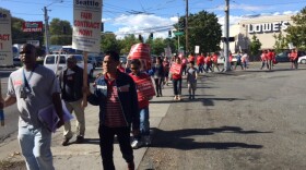 Teachers donned red shirts and picketed outside schools across Seattle on Wednesday. They will vote on whether to strike on Thursday evening. 