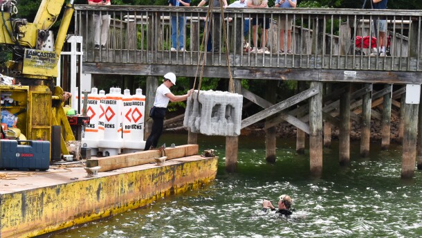 Clark and Clay Lancaster lower the artificial reef into the waters of Lake Norman State Park. 