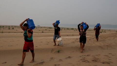 Residents transport drinking water from Humaita to the Paraizinho community, along a dry part of the Madeira River, a tributary of the Amazon River, amid a drought, Amazonas state, Brazil, Sep. 8, 2024.
