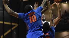 Florida defenders Dorian Finney-Smith (10) and Kevarrius Hayes (13) double team Vanderbilt's Damian Jones (30) as he goes up for a shot in the first half. (Greenberry Taylor/WUFT News)