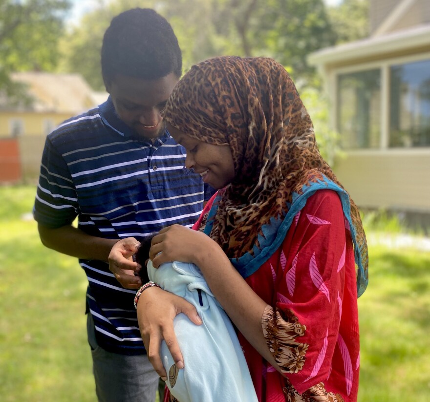 Rumbila Abdullahi, Ibrahim Abdi and their newborn son, Nabeel. Custom in Somali Bantu culture dictates that a newborn's face not be fully photographed until the child is at least six months old.