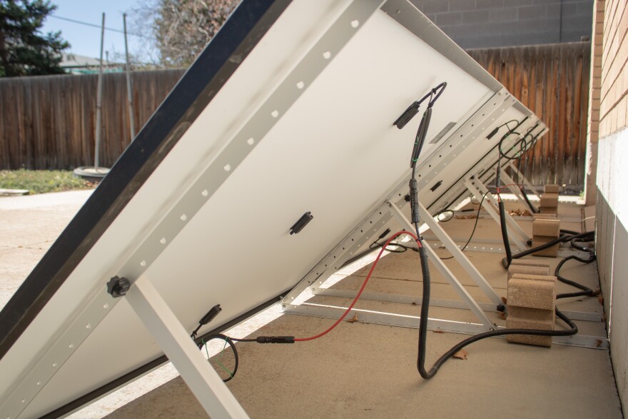 Cables run from Alex Giesey's panels into his garage, where they connect to a combined battery and microinverter, March 20, 2026.