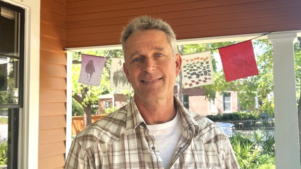 Christian Wagley stands on the front porch of his restored 1920s bungalow in Pensacola’s Old East Hill neighborhood. Once slated for demolition, the home was relocated and preserved by Wagley in the late 1990s. He sees efforts like this as part of a broader environmental ethic. Reuse what already exists, reduce waste, and make thoughtful choices that last.