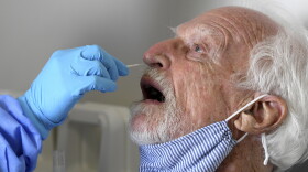 This Wednesday, Sept. 2, 2020, file photo shows National Institutes of Health-funded Moderna COVID-19 vaccine study participant William Webb getting a COVID-19 test nose swab by University of Miami Miller School of Medicine nurse Loreta Padron, in Miami. Miami is one of 89 cities around the U.S. that's testing the Moderna COVID-19 vaccine. Sen. Rob Portman, R-Ohio, is participating in a COVID-19 vaccine study, hoping to encourage others to volunteer to take part in testing. 