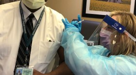 Shelby County's health officer, Dr. Bruce Randolph, receives a COVID-19 vaccine. 