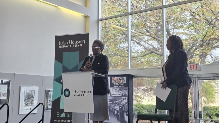 Burlinda Radney, president of the Historic Greenwood Main Street Program, speaking to an audience at the Greenwood Cultural Center during the launch of the Tulsa Housing Impact Fund on Nov. 19, 2025, as Housing Partnership Network President & CEO Robin Hughes looks on.