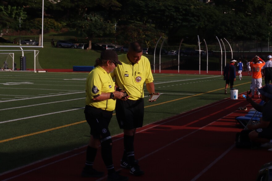 Referee Raymond Kaleo Benz confers with another referee during a Punahou vs. Saint Louis soccer game on Jan. 8, 2026.