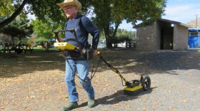 Lew Somers pulls a ground-penetrating radar instrument at Kam Wah Chung State Heritage Site