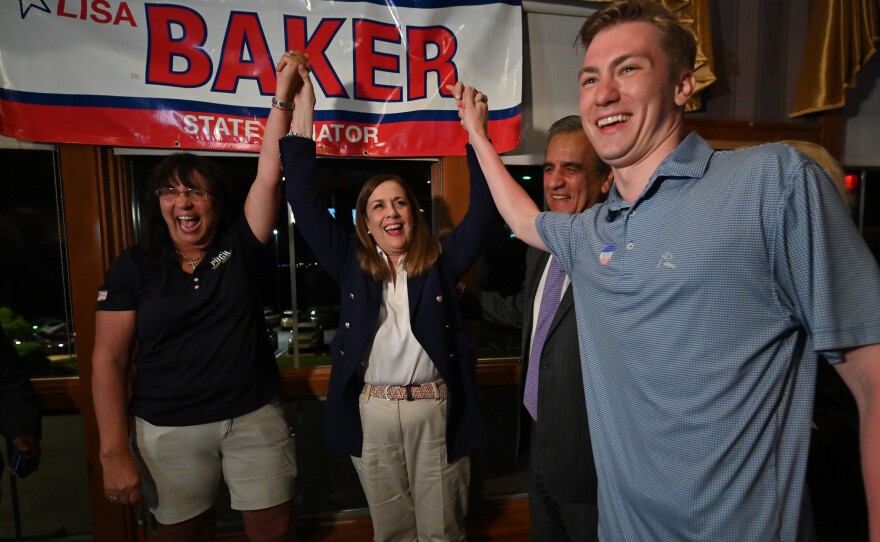 Brenda Pugh and Alec Ryncavage flank Lisa Baker after she declared victory in the 20th Senatorial District.