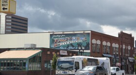 A billboard along Michigan Avenue downtown that reads, "Greetings from Lansing, Michigan, Alive After 5"