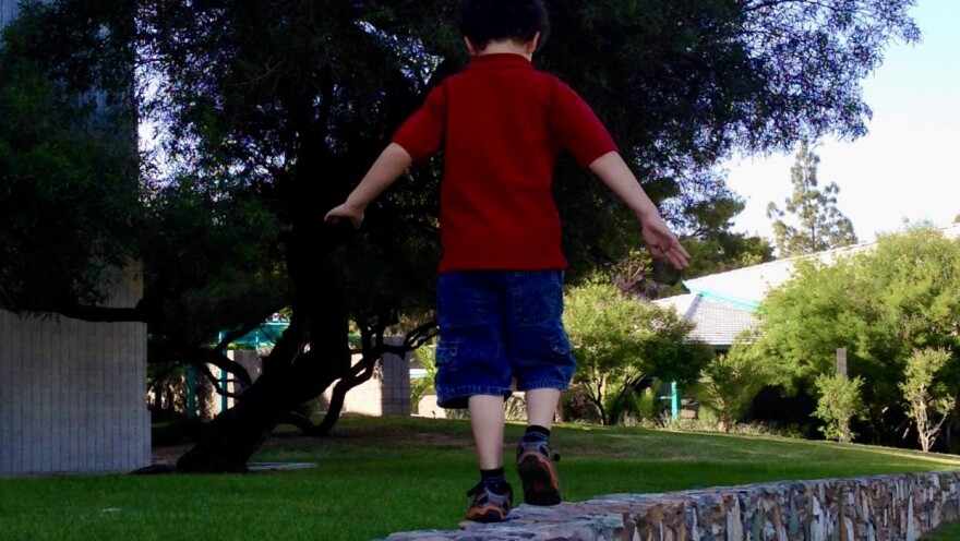 child walking on a wall