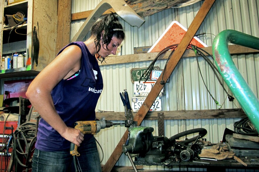 Shelby Miller tools on a part for a car for the derby. Miller comes from a derby family — her mother, father, and brother all participate.