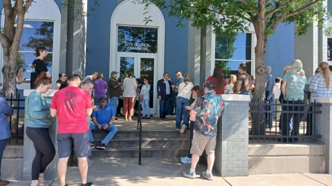 Residents stand outside Conway City Hall to oppose data center.