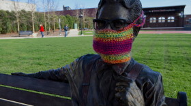 A statue of Orville Redenbacher in downtown Valparaiso with a knit mask over its face.