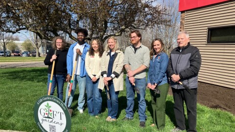Celebrating the launch of the 2026 GIFT Gardens program Monday, April 6, outside the Scott County Extension in Bettendorf are (L-R) Ann McGlynn, Fidele Muragara, Samantha Culver, Tayler Louscher, Mitchell Walker, Emily Swihart and Dave Phillips.