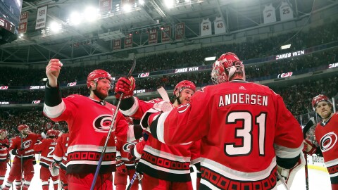 Carolina Hurricanes goaltender Frederik Andersen (31) is congratulated by Jordan Staal, left, and Mackenzie MacEachern, center, on the team's overtime win against the New Jersey Devils in Game 5 of an NHL hockey Stanley Cup second-round playoff series in Raleigh, N.C., Thursday, May 11, 2023.
