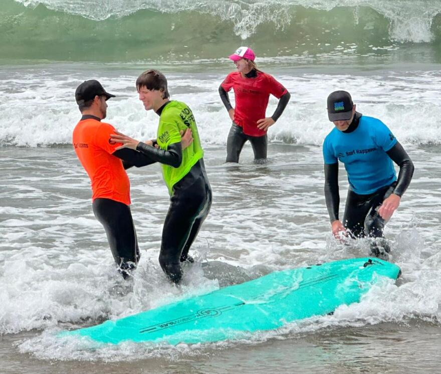 Some 60 volunteers helped blind, or low vision surfers in the Blind Fitness Surf Clinic.