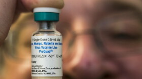 In this Thursday, Jan. 29, 2015 file photo, a pediatrician holds a dose of the measles-mumps-rubella (MMR) vaccine at his practice in Northridge, Calif. (Damian Dovarganes/AP)