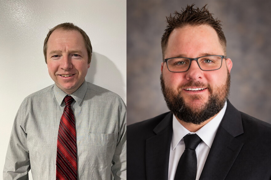 Two photos are placed next to each other. A middle aged white man is in the left photo. He wears a grey button down shirt with a red and black diagonal striped tie. He has short brown hair and eyebrows and he's standing against a white wall. A younger looking white man is in the photo on the right. He has brown hair, a mustache and a clean cut looking beard. He is wearing a dark blue dress coat, a dark blue tie and a white button down shirt. The background has faded dark blues, tans and greys.