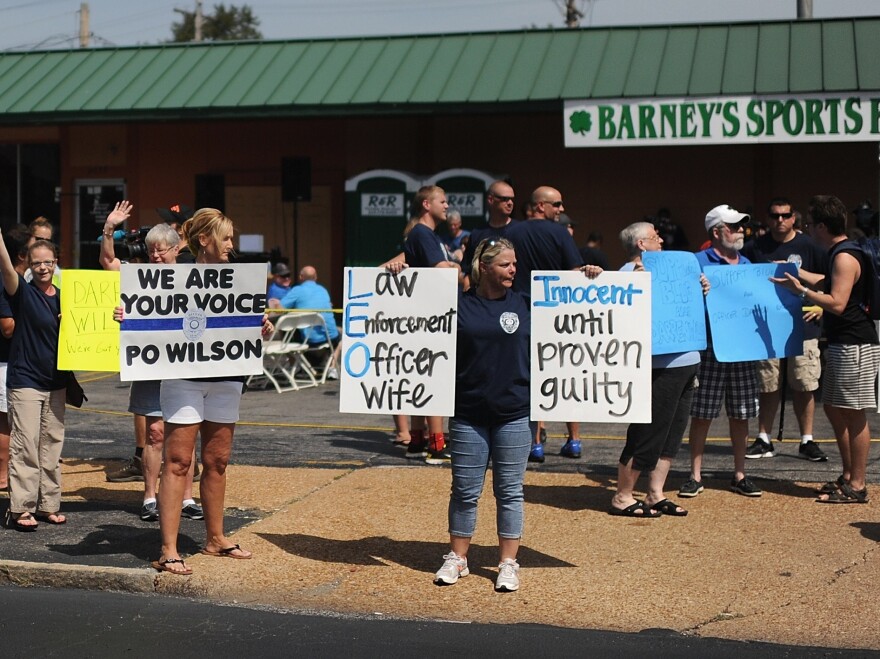 Protesters rally in support of Darren Wilson, the Ferguson police officer who shot Brown. Supporters have raised more than $400,000 for Wilson.