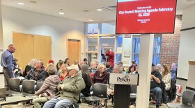 Pekin City Council member Jake Fletcher, far left, chats with 