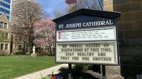 The sign in front of St. Joseph Cathedral in Columbus reminds parishoners the church is closed for in-person services.