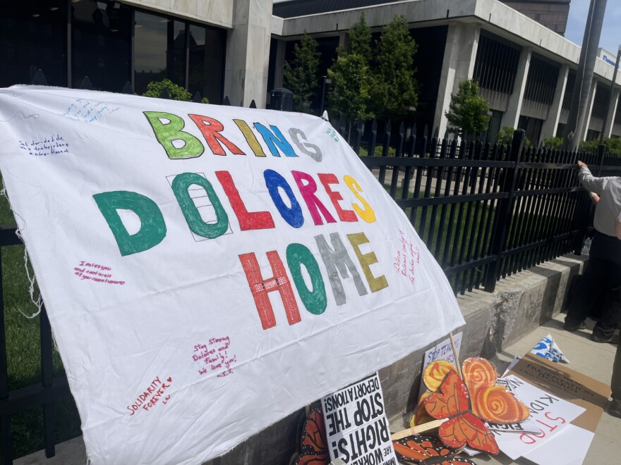 A banner tied to the fence outside the Kenneth B. Keating Federal Building reads "Bring Dolores Home," with added personal messages of support. The banner was hung on Tuesday, May 26, 2026. Inside the federal courthouse, Dolores Bustamante, a prominent Wayne County advocate for undocumented farmworkers, had a hearing over whether ICE violated her rights when agents detained her last month.