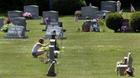 In this June 17, 2016 file photo, Erika Marble visits the gravesite of Edward Martin III, her fiancé and father of her two children, in Littleton, N.H. The 28-year old died Nov. 30, 2014, from an overdose of the opioid fentanyl. (Jim Cole/AP)