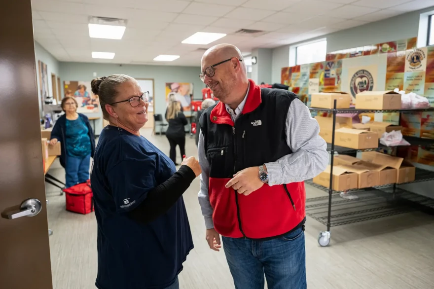 Craig Stoker, who director of Meals on Wheels Odessa, speaks with staff member Alice Drake on Dec. 3.