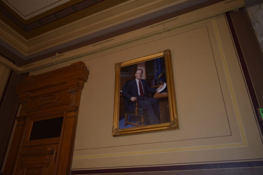 Former Gov. Frank O’Bannon’s portrait hangs in an Indiana Statehouse hallway as the state moves its official gubernatorial portraits into public view.