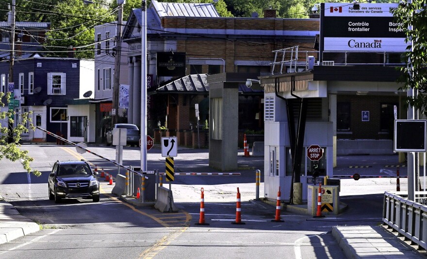 A vehicle in Canada waits for a gate to rise while crossing into Derby Line, Vermont from Stanstead, Quebec in July 2018.