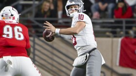 Washington State's quarterback John Mateer (10) looks to pass as he avoids the rush from New Mexico's Garrison Walker (96) during an NCAA college football game Saturday Nov. 16, 2024, in Albuquerque, N.M. (AP Photo/Roberto E. Rosales)