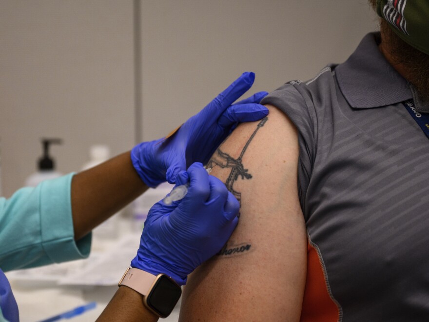 A Georgia Tech employee receives a Pfizer coronavirus vaccination on the campus of Georgia Tech on April 8. For a number of Americans, getting their shots is as easy as showing up to their workplace as some companies and institutions provide on-site vaccinations to their employees.