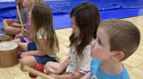Campers at Camp Noah in Floyd County play a game with musical instruments.
