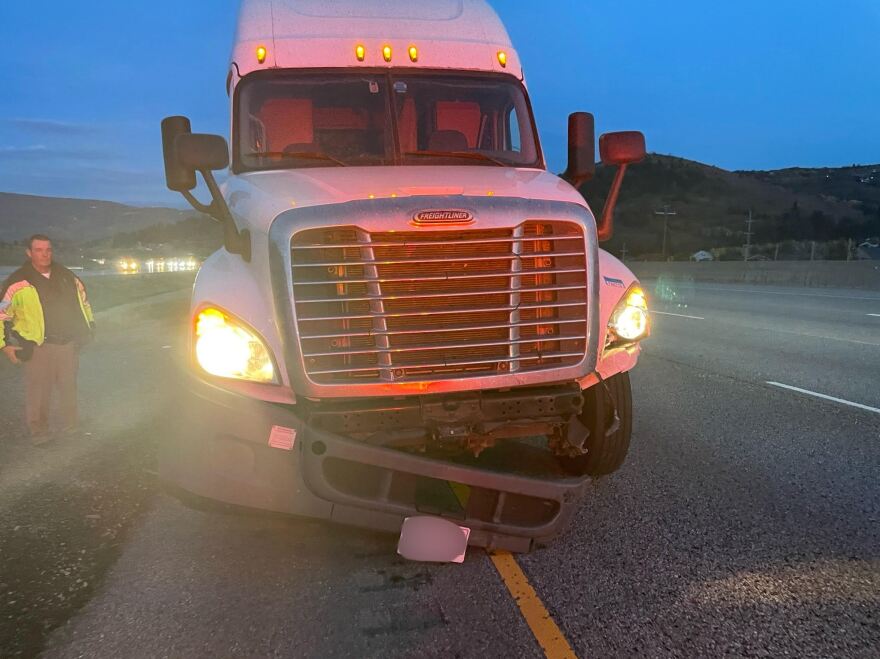 A semi truck's bumper is damaged after it hit multiple cars and crossed into the wrong side of the interstate near the Summit Park exit on I-80.