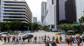 Brickell is a hot spot for the urban heat island effect in Miami. This section of Brickell Avenue, shown here during a protest against Florida governor Ron DeSantis, is roughly 12 degrees hotter because of the concentration of concrete and pavement, according to a report from Climate Central. 
