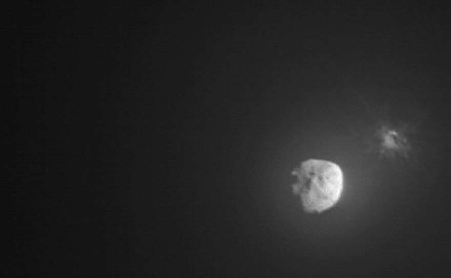 In this image made available by NASA, debris ejects from the asteroid Dimorphos, right, a few minutes after the intentional collision of NASA’s Double Asteroid Redirection Test (DART) mission on Sept. 26, 2022, captured by the nearby Italian Space Agency’s LICIACube. On Tuesday, Oct. 5, 2022l, NASA said the spacecraft succeeded in shifting its orbit.