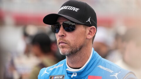 FILE - Denny Hamlin looks on prior to a NASCAR Cup Series auto race at Charlotte Motor Speedway, Sunday, Oct. 5, 2025, in Concord, N.C.