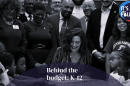 Whitmer signing budget bill surrounded by children and people