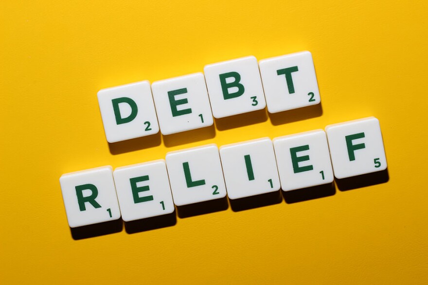 Tiles put together with the words "Debt Relief". Plain yellow background.