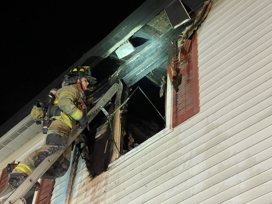 Firefighter on ladder outside apartment window